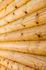close up wall of round wooden logs.