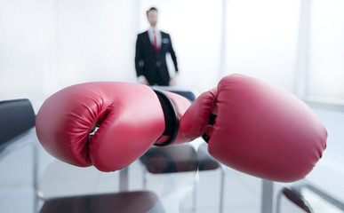 Boxing gloves on the table at the businessman