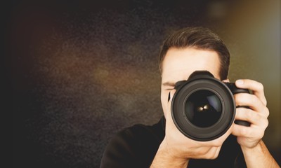 Male Photographer with Camera on black background