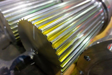Splined shaft lies on the rack after machining in oil, and is ready for further use in production.