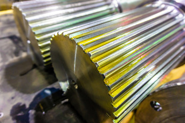 Splined shaft lies on the rack after machining in oil, and is ready for further use in production.