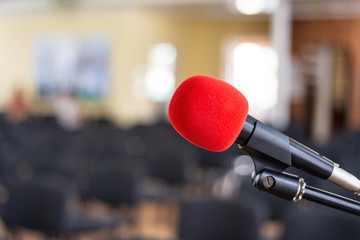 Red microphone in an empty room, the concept of emptiness and despair in human life, emptiness and...