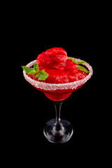 Closeup glass of red daiquiri strawberry cocktail decorated with mint isolated at black background.