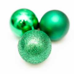 Three green christmas toys, decoration. Glitter. Isolated on white background