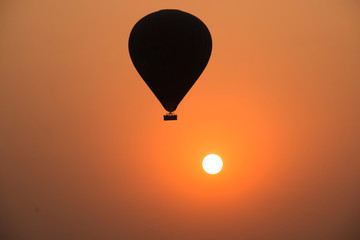 Hot air balloon with the sun in Bagan, a historical site in Myanmar, in the early morning
