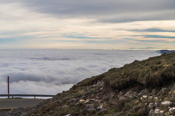 landscape of mountains at sunrise above the clouds, sea of clouds