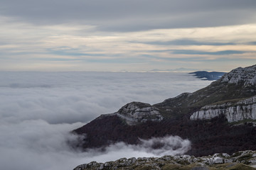 landscape of mountains at sunrise above the clouds, sea of clouds
