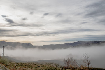 landscape of mountains at sunrise above the clouds, sea of clouds