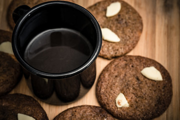Chip cookies homemade with white chocolate and a cup of black coffee. Delicious.