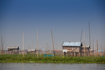 Fototapeta na wymiar Houses at the shore of Inle Lake, one of the top tourist attractions of Myanmar 