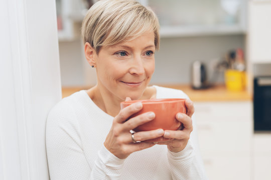 Woman enjoying a large cup of coffee or soup