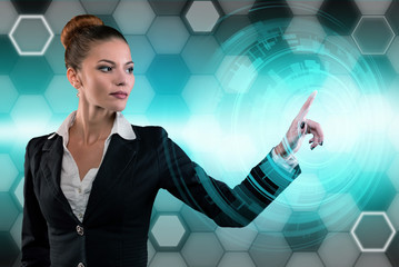 Young business lady works with virtual graphic interface in futuristic office