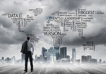 Motivation and inspiration concept with modern cityscape and businessman observing it