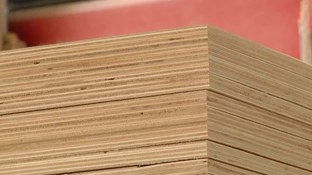 Furniture factory. Production of plywood. Automated production of plywood sheets. Stage plywood assembly. Sheets of plywood after trimming on the machine. 