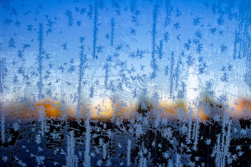 Inside frozen car, glass view, window covered with ice, early morning winter season