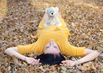  Beautiful pregnant woman outdoor in park on autumn