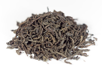 heap of black tea with shallow depth of field, isolated on white background 