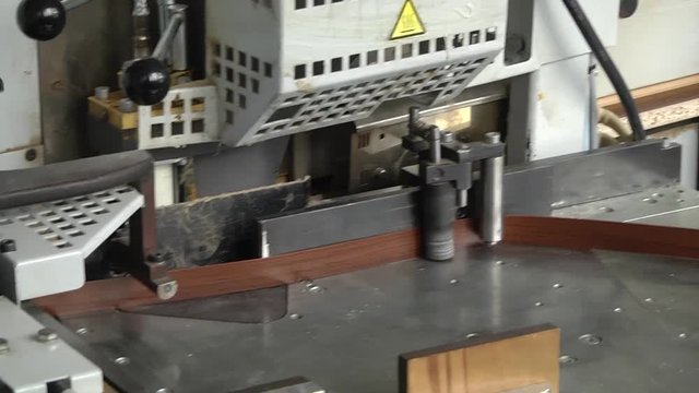 Finishing the edge of wood chipboards. Cnc machine handles wooden panels on the edging machine on the furniture factory
