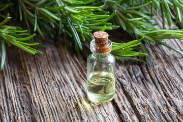 A bottle of rosemary essential oil on a table