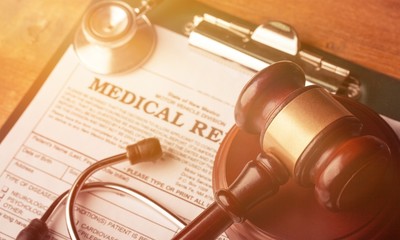 Wooden gavel and stethoscope on wooden background