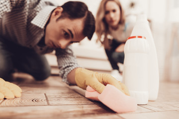 Woman Control Cleanerman on Floor in Apartment.