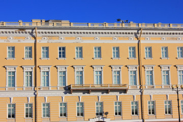 Obraz premium Old Historic Building Facade of Soft Yellow and White Color with Windows in Saint Petersburg, Russia. Classic Russian City House Exterior, Front View of Traditional European Style Building in Russia