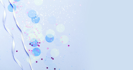 Blue festive confetti, glitter and stars background