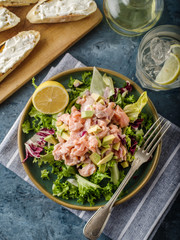 Ceviche is a traditional dish from Peru. Salmon marinated in lemon with fresh lettuce, avocado and onions
