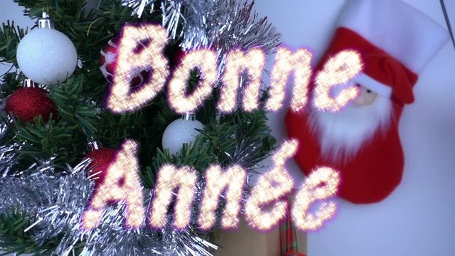 Christmas concept in super slow motion with text announcement Bonne Annee