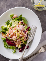 Ceviche is a traditional dish from Peru. Salmon marinated in lemon with fresh lettuce, avocado and onions