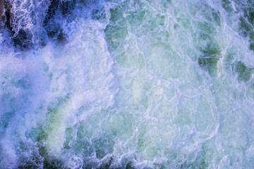Texture of boiling water, waterfall, mountain river, boiling streams with foam
