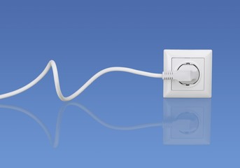 White electrical plug in the electric socket on a wall