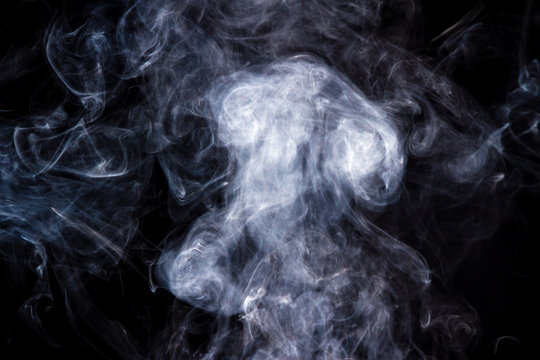 Thick smoke on a black isolated background. Background from the smoke of vape