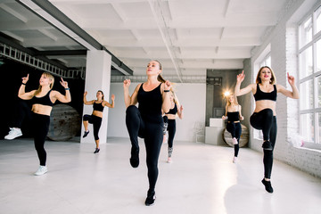 Naklejka premium Happy positive smiling men women performing modern dance in fitness studio