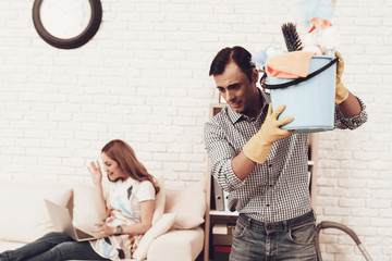 Man with Cleaner Accessories and Woman in Sofa.