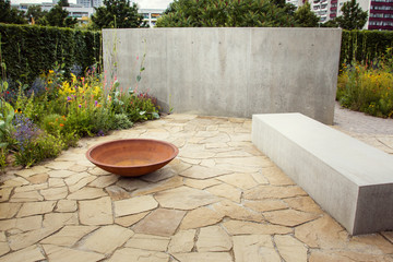 Corten fireplace in front of the concrete wall