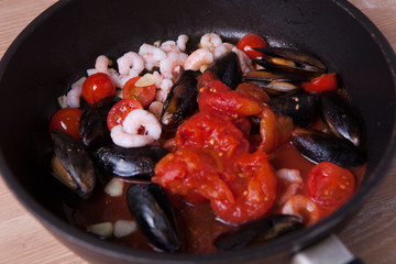 Seafood and tomatoes in a pan