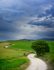 Fototapeta na wymiar Winding road to a destination in Tuscany