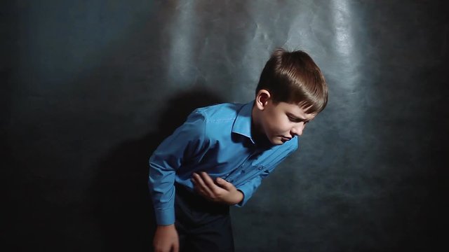 little boy hurts his stomach. Young blond European German businessman gastritis disease ulcer bad unhealthy food fast food schoolboy lifestyle. idea concept for business boy teen