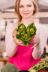 Womna holding green lettuce