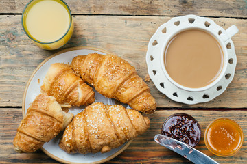Black coffee and croissant with jam. Typical French Breakfast (Petit Déjeuner) background.