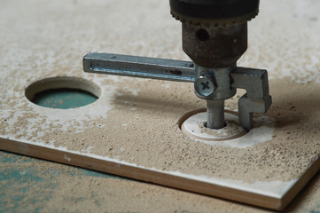 Building. Drilling holes in tile tile cutter.