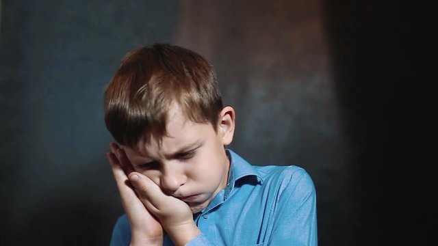 little boy has a toothache studio on black background. Young blond European German businessman little boy caries mouth inflammation dentistry dentistry schoolboy. idea concept for business boy