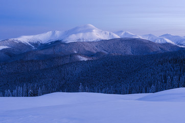 Winter landscape with a snowy mountain peak