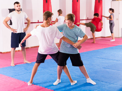 Kids practicing in pair self-protection