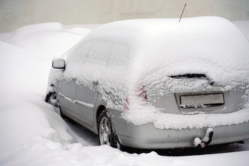 A car under a pile of snow.