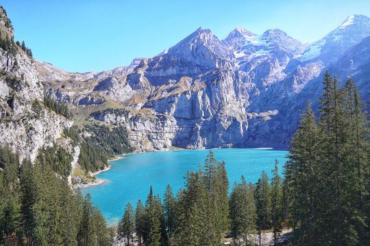 Scenic Panorama picture or postcard view of Oeschinensee lake,Wooden chalet and Swiss Alps, Beautiful outdoor scene in Berner Oberland,Kandersteg Switzerland.Vacation Holiday. 
