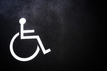 Disabled people icon or Handicap symbol on parking space.Sign design on urban asphalt road.Wheel chair logo on copy space empty blank.Disability Concept.
