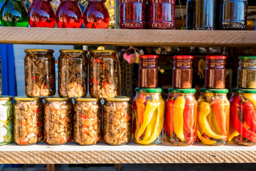 Preserved autumn vegetables and jam in jars