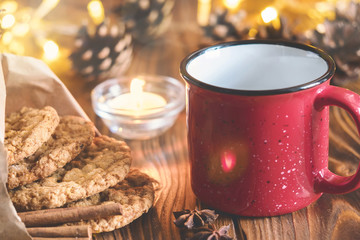 Tea mug with homemade oatmeal cookies, cinnamon and anise seeds